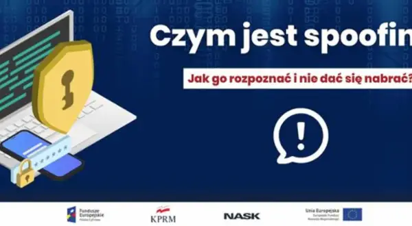 Czym jest spoofing? Grafika przedstawia laptop, telefon i tarczę z kluczem, symbolizujące bezpieczeństwo. Dowiedz się, jak rozpoznać spoofing i nie dać się nabrać.