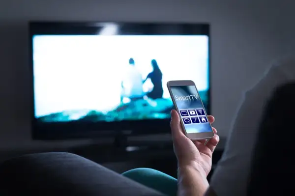 Smartfon steruje telewizorem przez Wi-Fi, wyświetlając obraz z telefonu na TV.